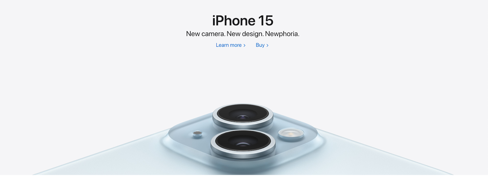 Closeup photo of iPhone's camera lenses. Heading reads "iPhone 15. New camera. New design. Newphoria."